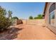 Expansive backyard featuring gravel and secure fencing, providing a blank canvas for outdoor activities at 1625 W Gunstock Loop, Chandler, AZ 85286