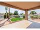 Covered patio overlooking the lake and yard space with views of lush lawn and surrounding trees at 1625 W Gunstock Loop, Chandler, AZ 85286