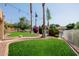 Lush backyard with manicured lawn, landscaping, and views of the lake creating a tranquil setting at 1625 W Gunstock Loop, Chandler, AZ 85286