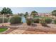 Scenic backyard with a wrought iron fence and mature trees, creating a serene and private outdoor space at 1625 W Gunstock Loop, Chandler, AZ 85286