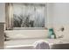 Soaking tub is situated underneath a window overlooking the backyard at 1625 W Gunstock Loop, Chandler, AZ 85286