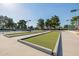 Well-maintained bocce ball court surrounded by mature trees, offering a recreational space in the community at 1625 W Gunstock Loop, Chandler, AZ 85286