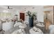 Dining area featuring a dark wood table set for six, with a front door and living room visible beyond at 1625 W Gunstock Loop, Chandler, AZ 85286