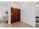 The double wood front doors open into a bright entryway with tiled floors and views into other living spaces at 1625 W Gunstock Loop, Chandler, AZ 85286