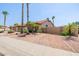 Desert-landscaped home with a three-car garage, stone accents, palm trees, and a private, gated side yard at 1625 W Gunstock Loop, Chandler, AZ 85286