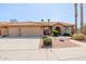 Charming single-story home featuring a tile roof, stone accents, desert landscaping, and a spacious three-car garage at 1625 W Gunstock Loop, Chandler, AZ 85286