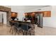 Kitchen features a stone-clad island with seating, wood cabinets, and stainless steel appliances at 1625 W Gunstock Loop, Chandler, AZ 85286