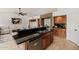 Bright and airy kitchen features a split-level island with seating, granite counters, and wood cabinets at 1625 W Gunstock Loop, Chandler, AZ 85286