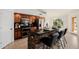 Inviting kitchen with stone island, barstool seating, dark granite countertops, and stainless appliances at 1625 W Gunstock Loop, Chandler, AZ 85286