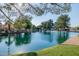 Scenic lake view surrounded by lush trees and landscaping, offering a tranquil setting for waterfront homes at 1625 W Gunstock Loop, Chandler, AZ 85286