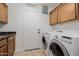 Functional laundry area with modern washer and dryer, along with practical storage cabinets and countertop at 1625 W Gunstock Loop, Chandler, AZ 85286