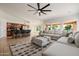 Spacious living area connected to the kitchen with a large sectional sofa and a ceiling fan at 1625 W Gunstock Loop, Chandler, AZ 85286