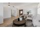 Spacious living area with tile floors, white walls, and a stone accent wall leading to the kitchen at 1625 W Gunstock Loop, Chandler, AZ 85286