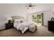 Bedroom with a tufted headboard and sliding door leading to a private outdoor space at 1625 W Gunstock Loop, Chandler, AZ 85286