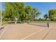 Outdoor pickleball court with net, benches, and trees providing shade in a well-maintained community park at 1625 W Gunstock Loop, Chandler, AZ 85286