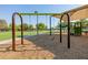 Community park with swings and modern playground equipment on a soft wood chip surface at 1625 W Gunstock Loop, Chandler, AZ 85286