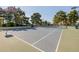 Well-maintained tennis court surrounded by mature trees, offering a great space for recreational play at 1625 W Gunstock Loop, Chandler, AZ 85286