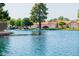 A beautiful waterfront home with mature trees, lush landscaping, and a tranquil lake view at 1625 W Gunstock Loop, Chandler, AZ 85286