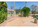 Picturesque waterfront view with a brick-lined patio, mature trees, and a white fence at 1625 W Gunstock Loop, Chandler, AZ 85286