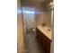 Bathroom with a shower, tub, vanity and natural light at 17335 W Woodlands Ave, Goodyear, AZ 85338