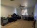 A spare bedroom with a ceiling fan and filled with dark furniture at 17335 W Woodlands Ave, Goodyear, AZ 85338