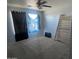 Spacious bedroom featuring natural light, a ceiling fan, and bare floors at 17335 W Woodlands Ave, Goodyear, AZ 85338