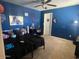 Blue bedroom with desk, bed, and decor at 17335 W Woodlands Ave, Goodyear, AZ 85338