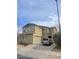 Tan two-story home featuring a two-car garage and a modern driveway at 17335 W Woodlands Ave, Goodyear, AZ 85338