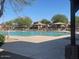 Community pool area features a sparkling pool, cabanas, and lounge chairs for relaxing by the water at 17335 W Woodlands Ave, Goodyear, AZ 85338