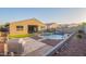 Beautiful backyard featuring a pool, patio, and well-manicured landscaping at 18630 W Lawrence Ln, Waddell, AZ 85355