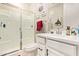 Bright bathroom features a glass shower, white vanity, and modern decor at 18630 W Lawrence Ln, Waddell, AZ 85355