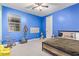 Bright bedroom features fun decor, a window, and a ceiling fan at 18630 W Lawrence Ln, Waddell, AZ 85355