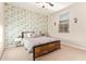 Bedroom featuring floral wallpaper, a window with blinds, and a ceiling fan at 18630 W Lawrence Ln, Waddell, AZ 85355