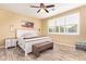 Cozy bedroom with a bed, nightstand, and window with shutters at 18630 W Lawrence Ln, Waddell, AZ 85355