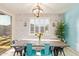 Charming dining area with rustic table, stylish chairs, and a decorative light fixture at 18630 W Lawrence Ln, Waddell, AZ 85355