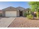 Inviting single-story home with a well-maintained front yard and a two-car garage at 18630 W Lawrence Ln, Waddell, AZ 85355