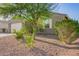 Single-story home displaying desert landscaping, window shutters, and a two-car garage at 18630 W Lawrence Ln, Waddell, AZ 85355