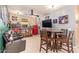 Entertaining game room featuring a rustic bar, seating area, and a TV at 18630 W Lawrence Ln, Waddell, AZ 85355