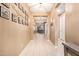 Bright hallway featuring neutral walls, tile flooring, and decorative wall decor at 18630 W Lawrence Ln, Waddell, AZ 85355
