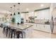 Spacious kitchen has a large island with bar stools, stainless appliances, and lots of natural light at 18630 W Lawrence Ln, Waddell, AZ 85355