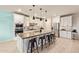 Bright kitchen features an island with seating, ample cabinets, and stainless steel appliances at 18630 W Lawrence Ln, Waddell, AZ 85355
