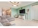 Cozy living room with stylish furnishings, tile flooring, and abundant natural light at 18630 W Lawrence Ln, Waddell, AZ 85355