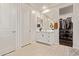 Bathroom featuring double sinks, a walk-in closet, and a neutral color palette at 18630 W Lawrence Ln, Waddell, AZ 85355