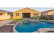 Lush backyard with a sparkling pool, an outdoor patio, and plenty of lounge space at 18630 W Lawrence Ln, Waddell, AZ 85355