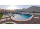 Inviting backyard pool with rock landscaping, waterfall feature, and lounge chairs at 18630 W Lawrence Ln, Waddell, AZ 85355