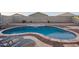 Stylish backyard pool with stone waterfall feature and paved patio area for entertaining at 18630 W Lawrence Ln, Waddell, AZ 85355