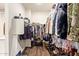 Walk-in closet with multiple hanging racks and shelving for shoes and accessories at 18630 W Lawrence Ln, Waddell, AZ 85355