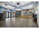 Bright gym space with ceiling fans, mirrored walls, and a variety of exercise equipment at 19777 N 76Th St # 3220, Scottsdale, AZ 85255