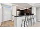 Kitchen featuring dark cabinets, breakfast bar with seating, and stainless steel appliances at 19777 N 76Th St # 3220, Scottsdale, AZ 85255
