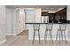 Modern kitchen with breakfast bar, dark cabinetry, and access to the dining and living areas at 19777 N 76Th St # 3220, Scottsdale, AZ 85255